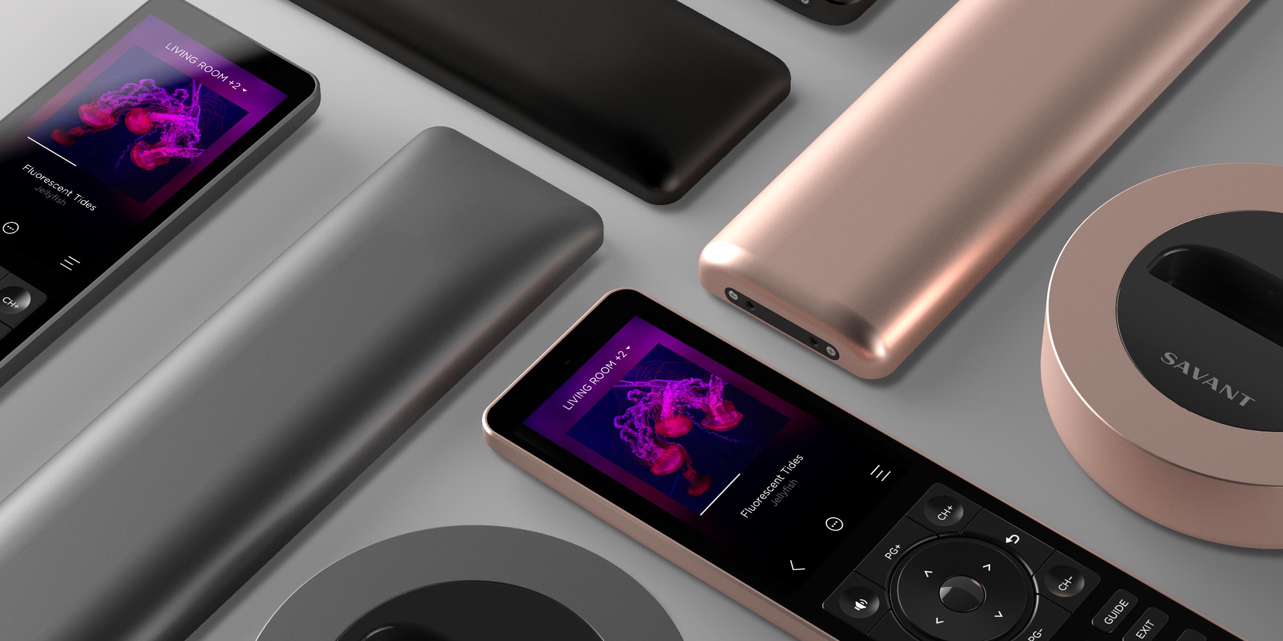 Savant remotes and charging bases displayed on a table in different colors